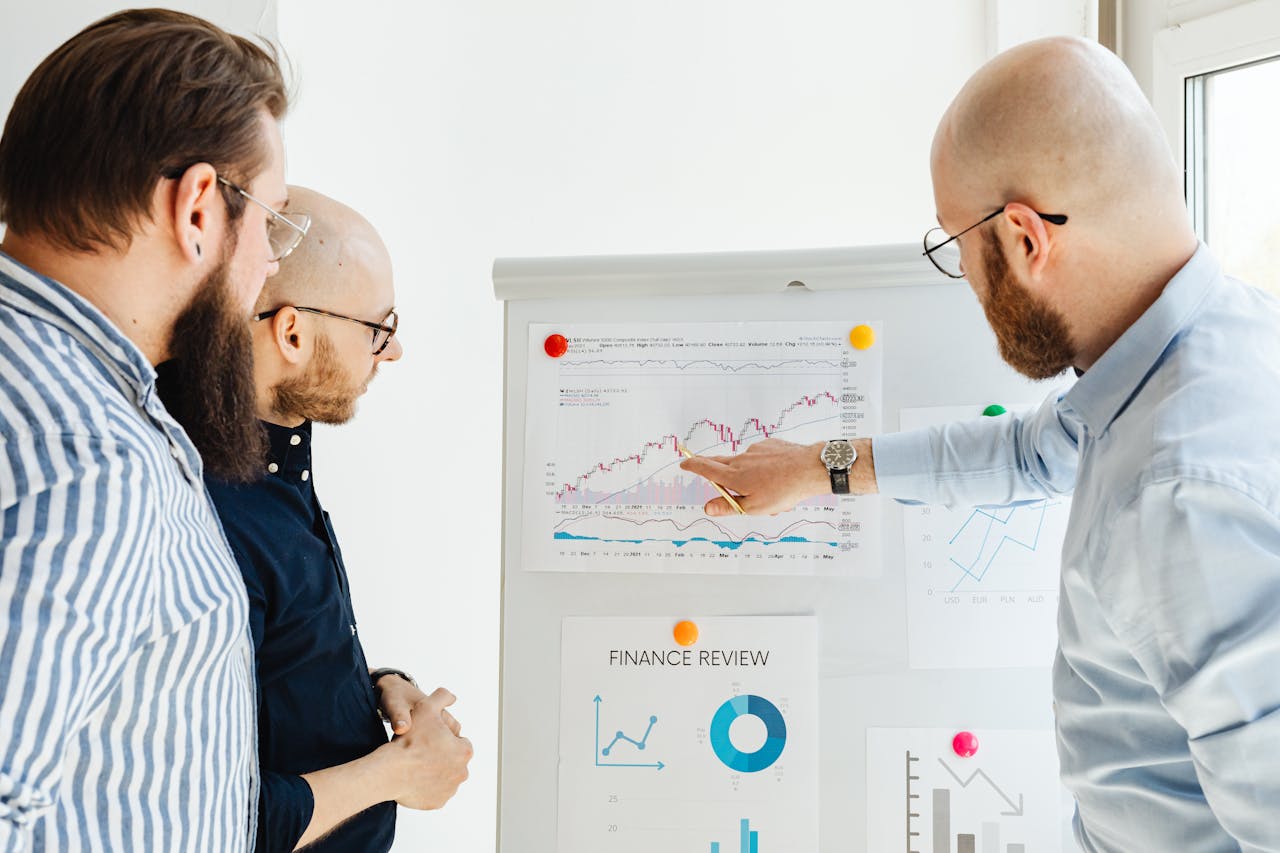 The Art of Drawing Readers In: Your attractive post title goes here Business team reviewing financial charts during a strategy meeting indoors.